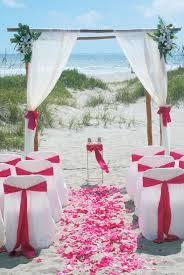 Beach Wedding Setup With Fuchsia Sashes Petals Www Centralfloridaweddinggroup Com Beach Wedding Setup Beach Ceremony Beach Wedding Packages