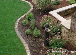 Paver Edging Creates A Good Clean Line To Transition From A Landscape Bed To Lawn Paver Edging Brick Garden Edging Garden Edging Tool