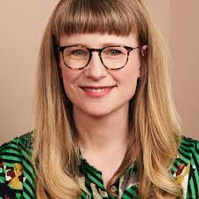 Three small children walk arm in arm through Hampstead Heath. With a  brilliant smile, the middle one suddenly shouts, 'We're together!'