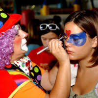 CHIEF Boatswain's Mate Frank Brant and CHIEF Aviation Electronics  Technician Bruce Berg try to cheer up a sick child at Mercy Hospital.  Dressed as Dr. Gadgets and Mr. Buttons, respectively, the two