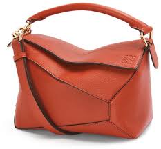 The bag features a rolled leather handle, a rear zipper pocket, and an optional, adjustable leather shoulder strap with polished silver hardware. Loewe Puzzle Bag Small Shop The World S Largest Collection Of Fashion Shopstyle