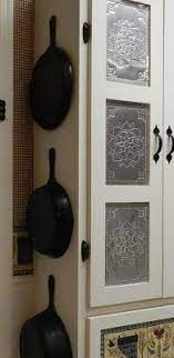 Once you paint the faux tin and it's dry, and paint or stain your door frame, use a hot glue gun to attach the faux tin panel to the plywood backing. Sweetpepperrose Punched Tin Paneled Country Cabinet Punched Tin Tin Panel Tin Kitchen