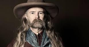 Portrait Of Man With Long Hair Wearing Cowboy Hat Long Hair Styles Men Cowboy Outfits Cowboy Hats