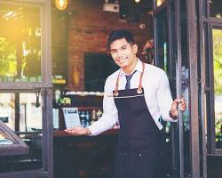 Gambar GRO greeting a guest with a smile