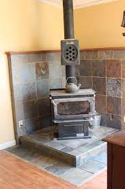 The hearth area to the right of the stove is for piling wood. Li L Buck S Creations Wood Stove Slate Tile Surround Wood Stove Wood Stove Wall Wood Burning Stove Corner