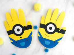 You will need yellow/blue paint, a black marker, white/pink paper, a bottle cap, and glue. Simple Handprint Minion Card Craft For Kids