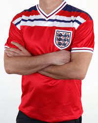 All products are licensed and a royalty is paid to the football association for every shirt or track jacket sold. England 1982 Retro Football Away Shirt Red 80s Casual Classics