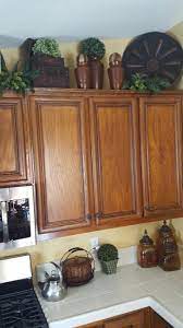 You can decorate the space above your kitchen cabinets using tall pieces especially if you have high ceilings. Tuscan Decor Decorating Above Kitchen Cabinets Kitchen Cabinets Decor Tuscan Decorating Kitchen