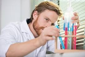 Scientist Examining The Label On A Test Tube In Closeup View Photo  Background And Picture For Free Download