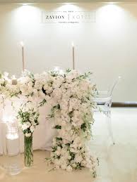 Brides Table With White Roses White Orchids And Champagne Table Cloths Candlelight And Flowing Flower Runners Wedding Decorations Orchid Wedding Bridal Table