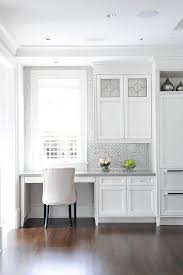 An Ivory Linen Chair Sits At A White Built In Desk Fixed In A Kitchen And Boasting A Gray Quartz Top Mount Kitchen Office Nook Kitchen Desk Areas Kitchen Desks