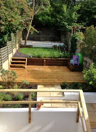 Designed Town Garden On Four Levels In Brighton Sussex Two Paved Patio Areas Are Separated By A Deck And A Circular Lawn Tiered Garden Deck Garden Hardscape