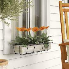 Small window flower box with a variety of flowers creating a miniature garden effect. Faux Window Box Flowers Wayfair