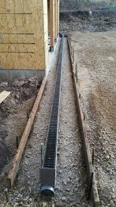 Each length of channel drain has integral bottom outlets. Trench Drain Driveway Before Eckles Paving