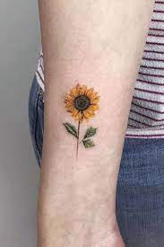 You can actually get your artist to do a huge sunflower field at your back, or place the sunflower inside your other tattoos, like a group of dolphins. Simple Sunflower Tattoo Designs To Carry Your Favorite Flower On Your Skin Sunflower Tattoos Cool Small Tattoos Tattoos