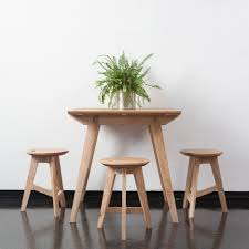 1200mm round white isotop table top with circular stainless steel base. Jan Hendzel Creates Bespoke Furniture For Pop Up Cafe