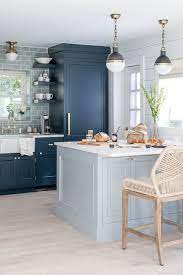 Neutral colored countertops and wooden open shelving keep this kitchen feeling natural. 15 Blue Kitchen Design Ideas Blue Kitchen Walls