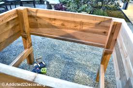 This waist high raised garden bed plan will show you how to build an attractive wooden planter box that has storage space underneath. How To Build An Elevated Garden Addicted 2 Decorating