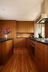The gorgeous natural wood of these dark cabinets complements the textures in the lighter wood flooring and give this a rustic, cottage feel without taking away from this classy kitchen. What Color Is Best For Laminate Flooring For Dark Cabinets