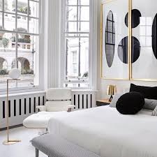 Thin white electrical wires of a modern pendant light scribble luminously across a subtly patterned black wall here. Modern White Black Gold Bedroom Novocom Top