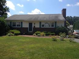Lovely ranch style home of red brick, white trim and black shutters with an american flag. Help I Need To Update My Ranch