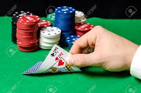 Hand In Foreground Holding Pocket Kings In Poker Stock Photo ...