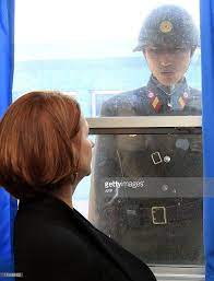 Australian Prime Minister Julia Gillard L And A North Korean Soldier Look At Eath Other Through The Window Of Th North Korea North Korean Life In North Korea