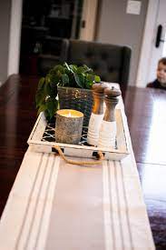 Traditional Style Kitchen With A Neutral Grey And Cream Table Runner Wit Dining Table Decor Everyday Dining Table Decor Centerpiece Table Centerpieces For Home