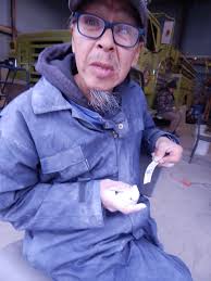 Sandy Tooma says “Qungappasi” to all as he leaves Tuttavik office today  carrying his belongings.