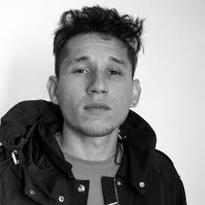 Skaters perform through a ring of fire at Go Skateboarding event