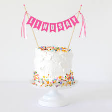 These 1st birthday cake ideas can all be used to plan the theme of their very first birthday party, with the this simple treat is vanilla cake layered with whipped cream and strawberries, topped with. How To Dress Up Simple Birthday Cakes With Paper Bunting Cake Toppers