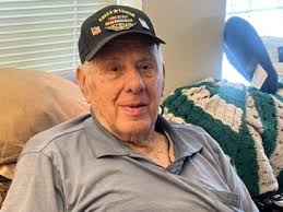 American Legion members honor their fellow veterans by placing flags