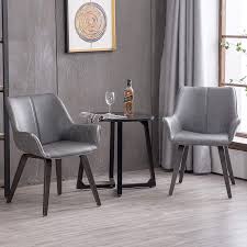 Dining arm chairs do tend to take up a little more room than side chairs so it's less common to find them around the rest of the table. Amazon Com Homy Grigio Modern Leatherette Dining Room Accent Arm Chairs Club Guest With Solid Wood Legs Set Of 2 Gray Chairs
