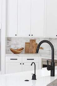 Matte Black Hardware Is Having A Moment And We X2019 Re Not Mad Via Purewow Black Kitchen Faucets White Kitchen Black Kitchens
