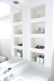 By painting the shelves the same color as the wall, the eye is not immediately drawn to them and they don't feel overwhelming. Pin By Gina Brikada On Inspiring Interiors Shelving Bathroom Wall Shelves Apartment Bathroom