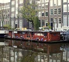 The Cat Houseboat On The Canals Of Amsterdam Amsterdam Floating House Canals