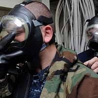 Machinist's Mate 2nd Class Aaron Tronti helps another