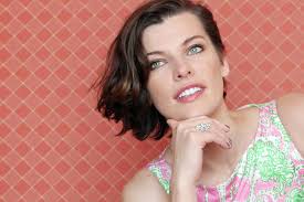 Julia was in the big chair by the fireplace, looking plumper than usual in her new green dress. Milla Jovovich Actress Into The Gloss