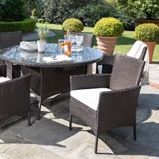 If your patio dining table is used most frequently by a small there are reasons to choose a round table over a square or rectangular one, and vice versa. 6 Seater Rattan Round Dining Table Set In Brown Garden Furniture Out Laura James