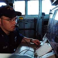 Aviation Boatswain's Mate (Equipment) 3rd Class Valentine Anibogwu, from  Rahway, N.J., mans the arresting gear engine aboard the aircraft carrier  USS Carl Vinson (CVN 70).