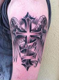 Wings symbolize freedom and the ability to soar. Dad Script Cross And Wings Tattoo By Skyler Del Drago Tattoonow