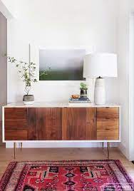 Crafted from teak, it boasts linear appeal with a stout profile elevated by thin yet durable legs for an airy feel. Midcentury Modern Entryway Styling Newman S Nest Living Room Decor Modern Home Decor House Interior