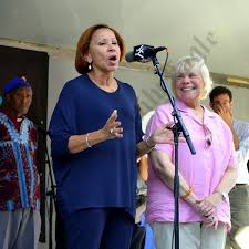 Joan Millman (in pink) is presented with the Atlantic Avenue Ambassador  Award by Christian Haag, Jo Anne Simon and U.S. Rep. Nydia Velazquez.