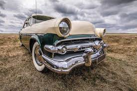 Download Closeup Shot Of A Vehicle On A Dry Field Under A Cloudy Sky For Free Old Vintage Cars Futuristic Cars Mini Van