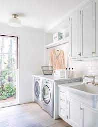 White Laundry Room With Apron Sink And Gray Wash Wood Floors Mudroom Laundry Room Laundry Room Design Laundry Mud Room