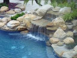 We have installed decks for some of miami's most prestigious hotels , condo complexes, and restaurants. Rock Waterfall And Pond Into Swimming Pool Contemporary Pool Miami By Matthew Giampietro Garden Design Houzz