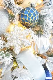 Elegant flocked christmas tree with blue and silver from our crafty mom. Flocked Christmas Tree Decor Blue Silver Gold Citrineliving