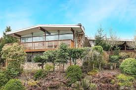 In a split level or split foyer floor plan, the front door opens to a landing or a floor containing the living room, dining room, and kitchen. A Split Level Time Capsule With Midcentury Modern Style Urban Living