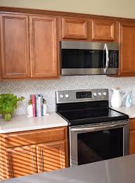 Custom magnets make this backsplash fun and functional how to: Diy Peel And Stick Backsplash Tile With Vinyl Dream A Little Bigger