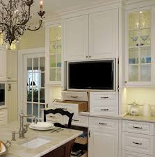 tv in kitchen cabinet with pocket doors